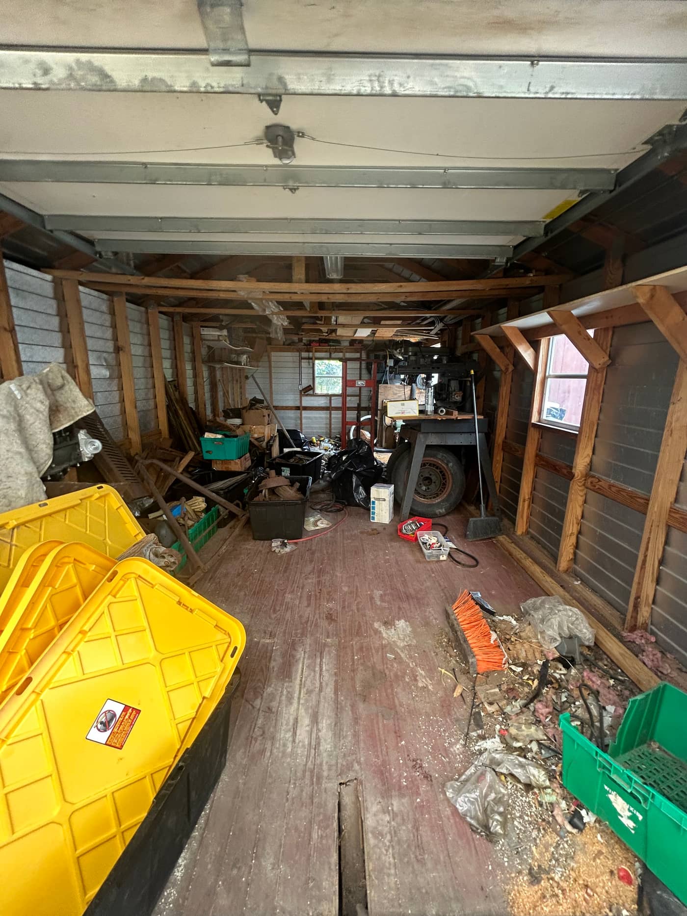 The same shed with the timber and machinery gone, the plank floor and the far window visible down its length